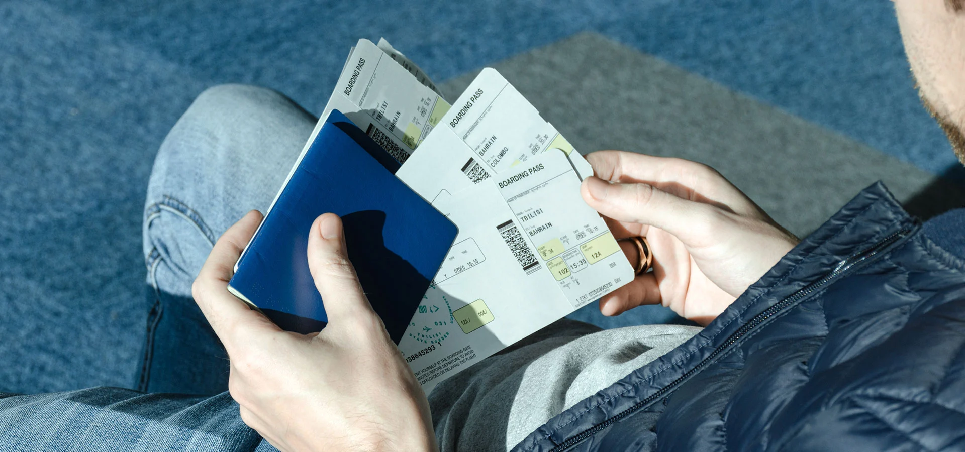 man-with-airplane-tickets-and-passport-4SYCE7N